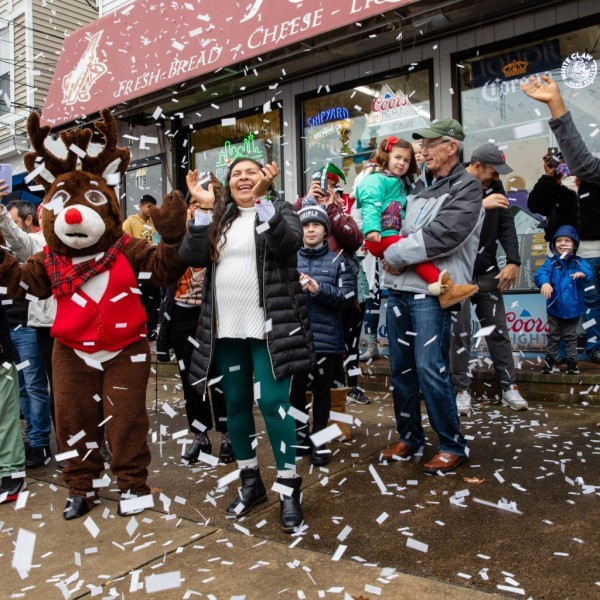 People cheer as confetti falls from above.