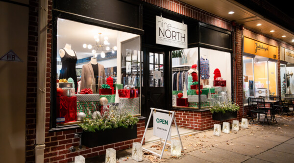 A downtown storefront with holiday decorations in the windows