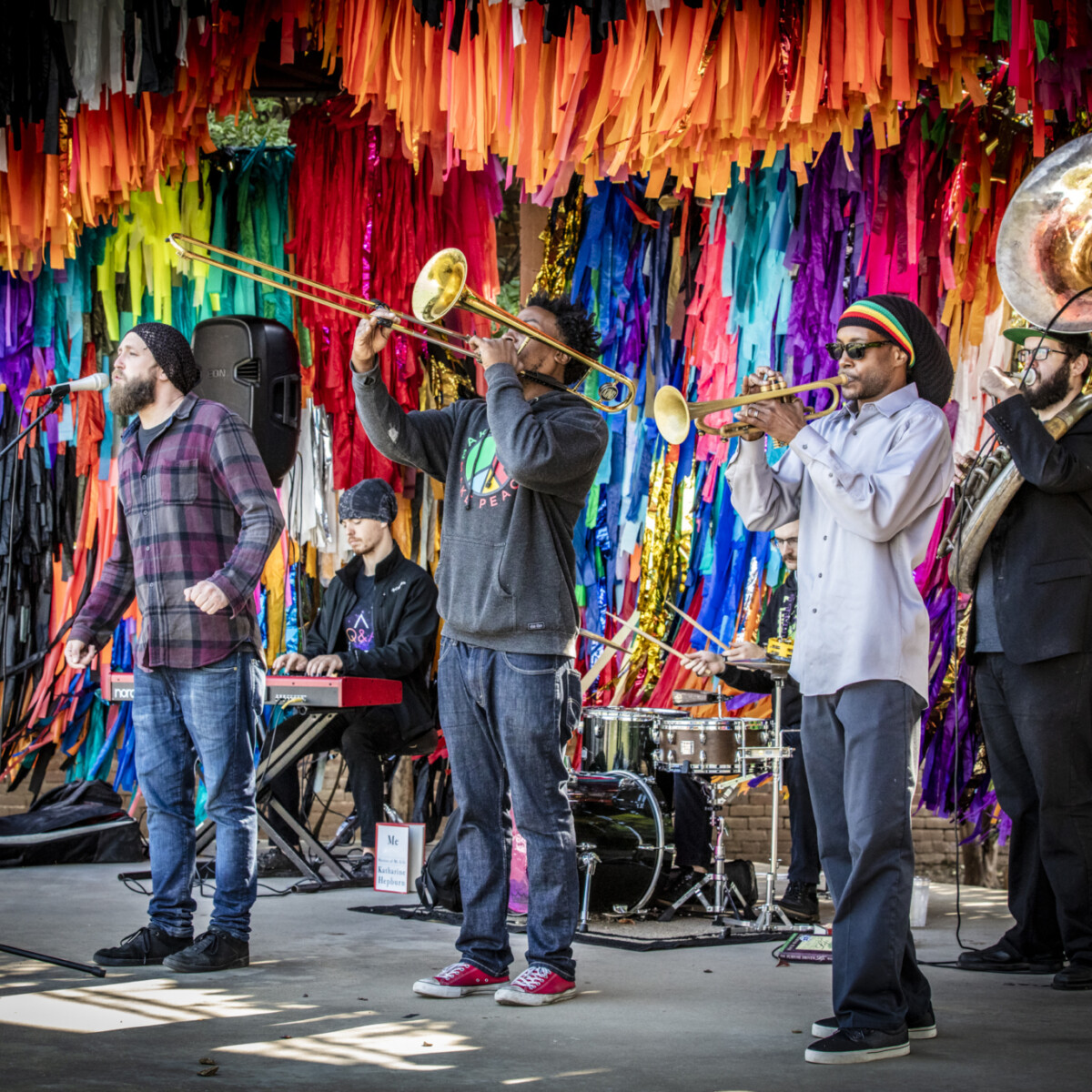 Six musicians perform on a stage.