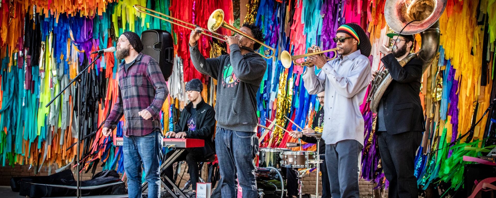 four members of a band performing on stage