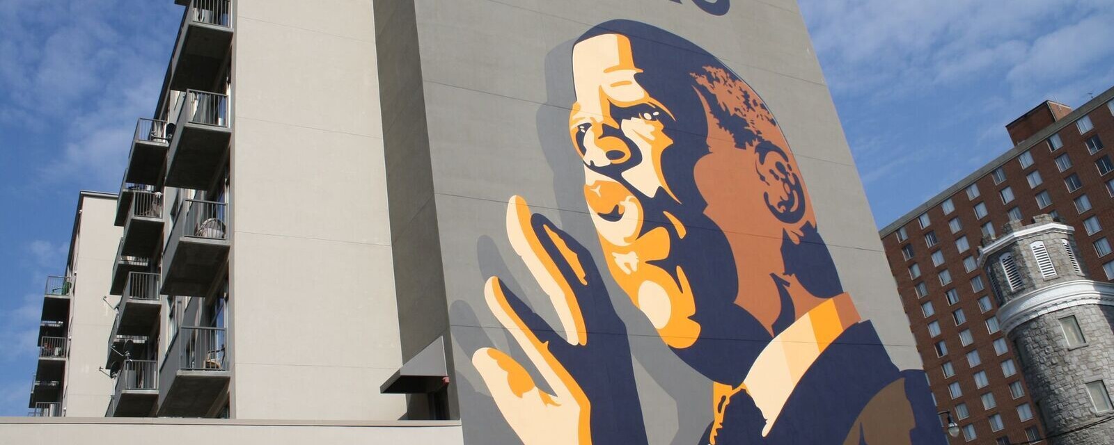 A large mural featuring John Lewis giving a speech
