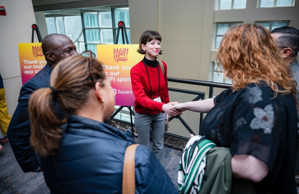 Two women shaking hands.