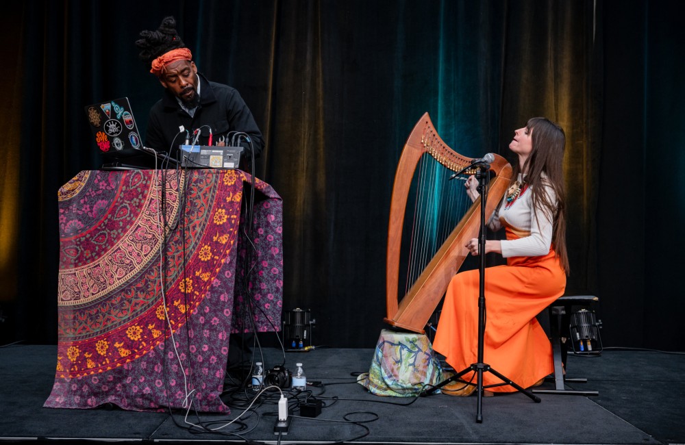 Two musician, a DJ and harpist, perform.