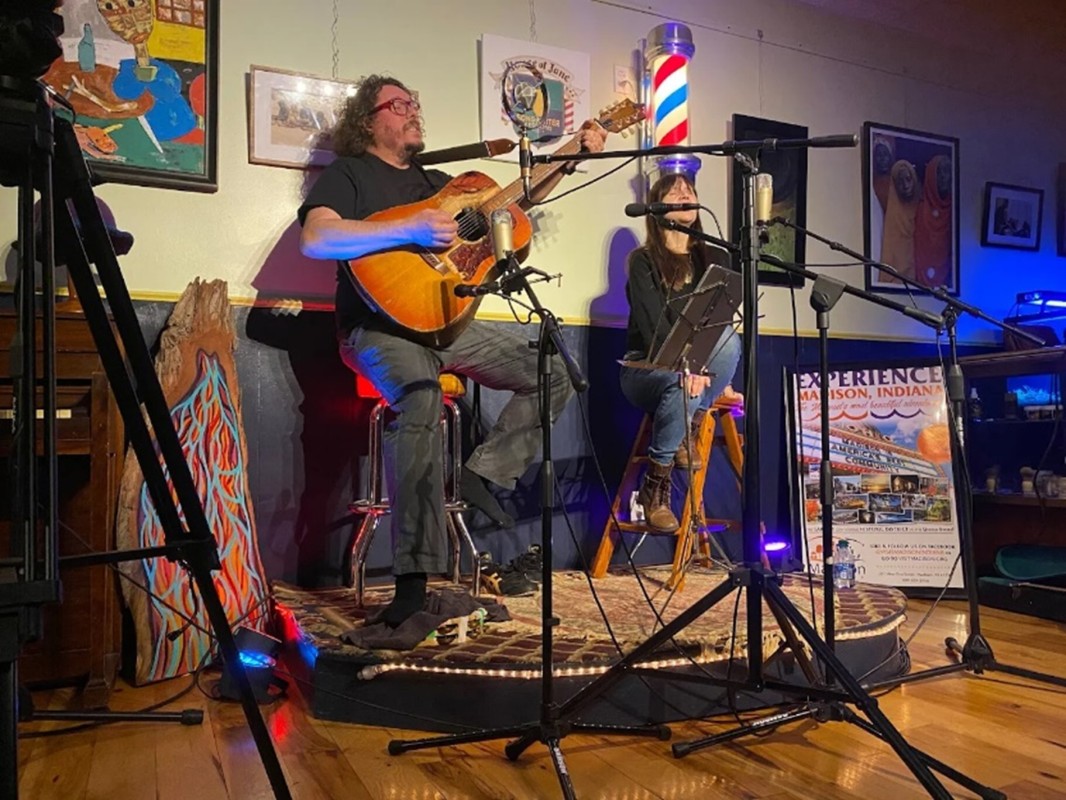 A man and woman on a stage performing a musical show
