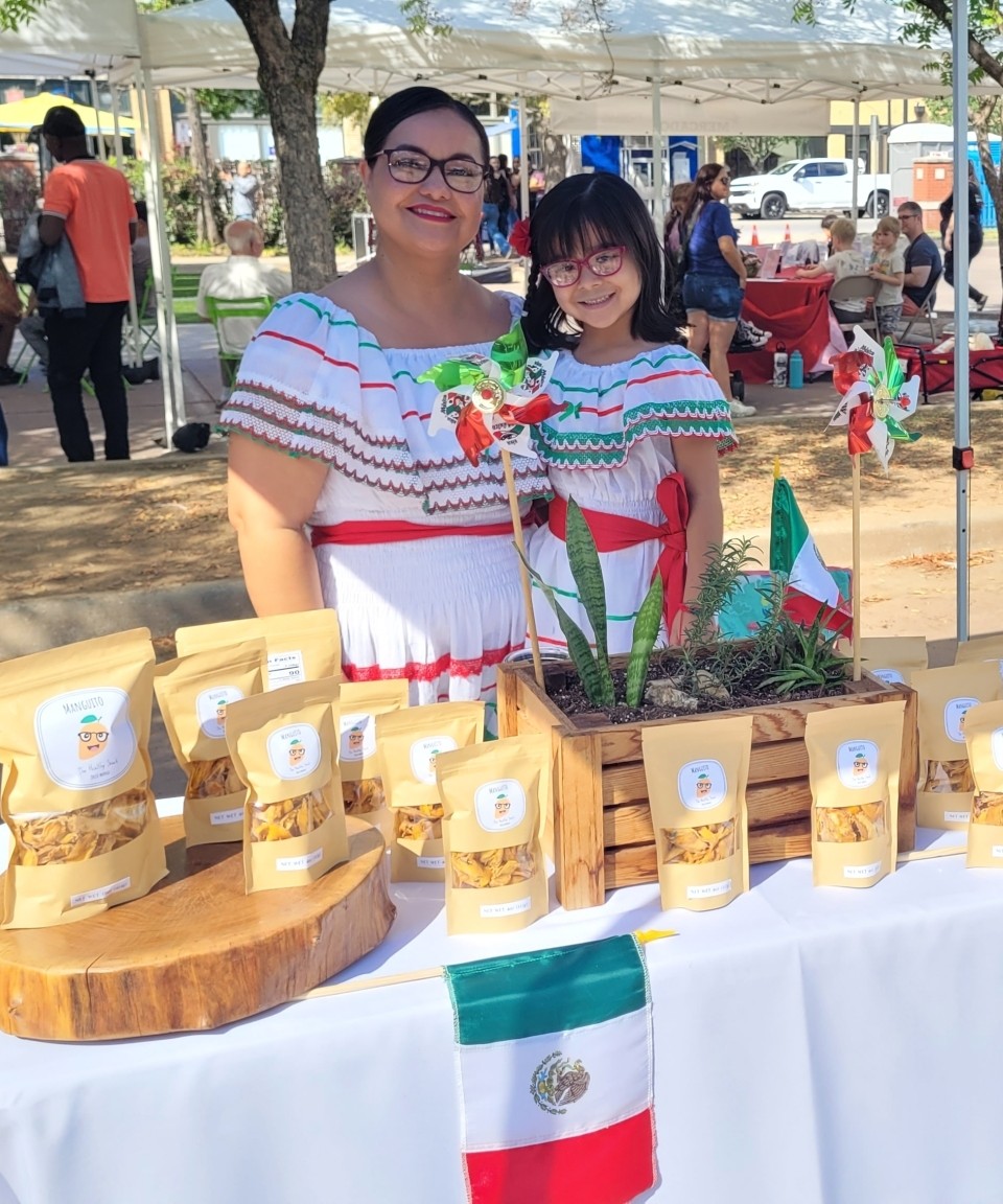Woman and girl at a festival booth in Kendall Whittier, Tulsa, Oklahoma.