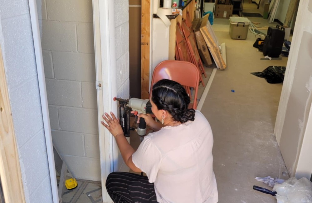 Woman building a door frame.