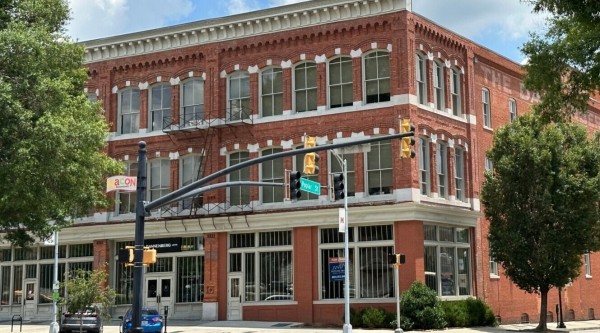 A historic brick building on a downtown street corner