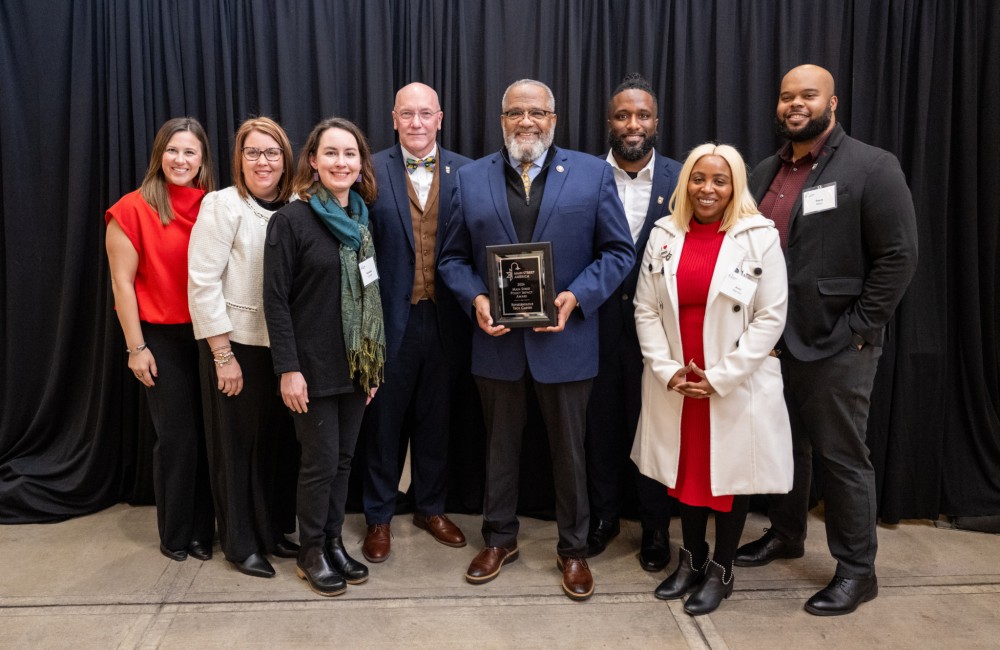 Rep Troy Carter poses with a group of people after receiving his award