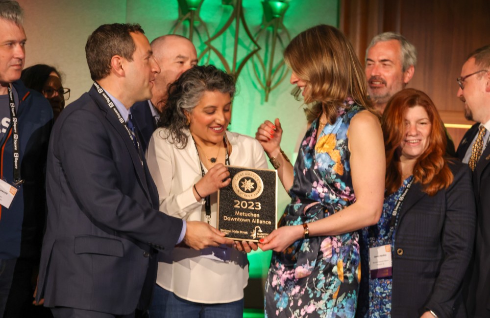 A team of people receiving a plaque.