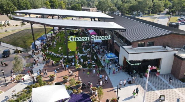 A large crowd of people exploring the farmers market at green street