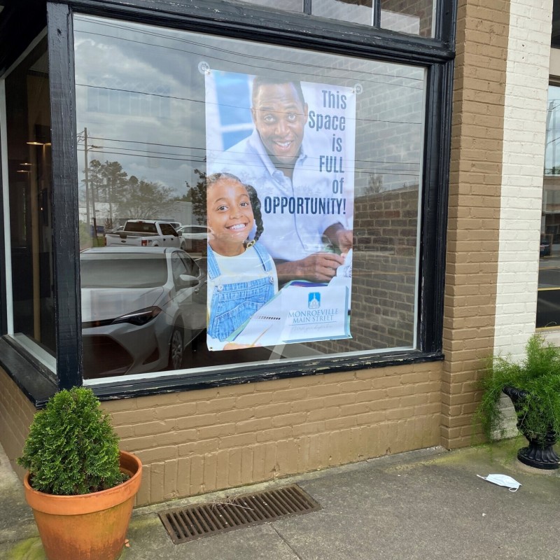 A sign promotes the availability of a vacant commercial space.