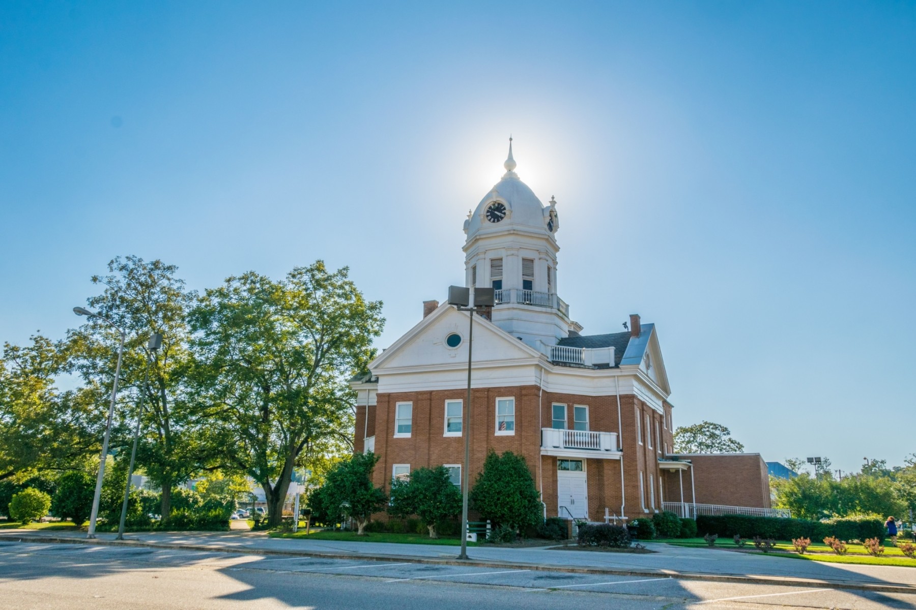 Historic courthouse building surrounded by trees.