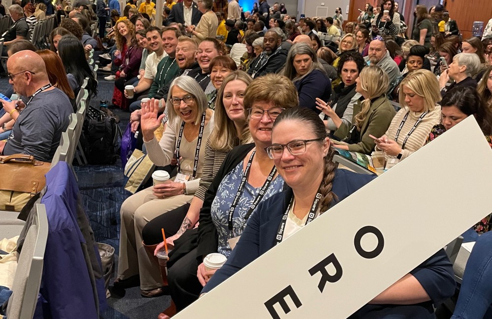 Large group of people at a conference. In the foreground is a large sign that reads "Oregon."