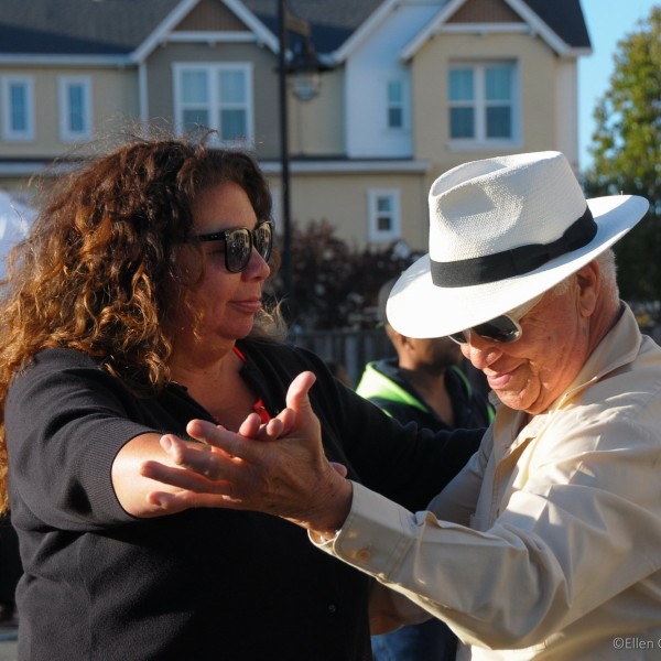 Two people dancing downtown.