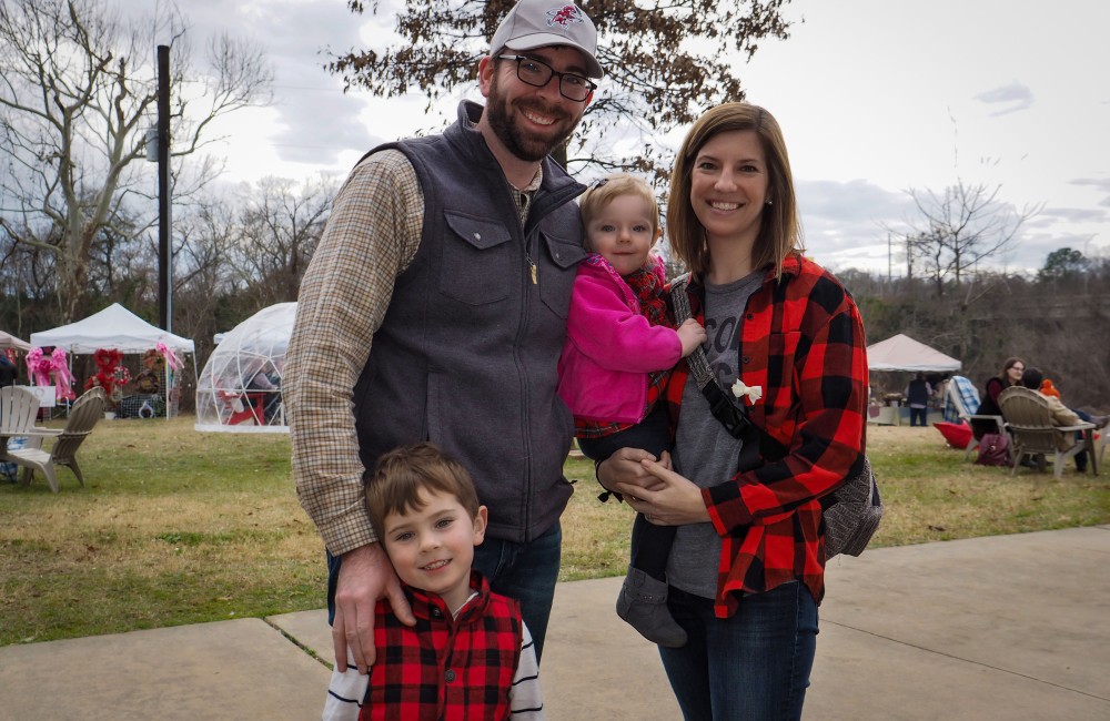 A man, woman, and two children posing.
