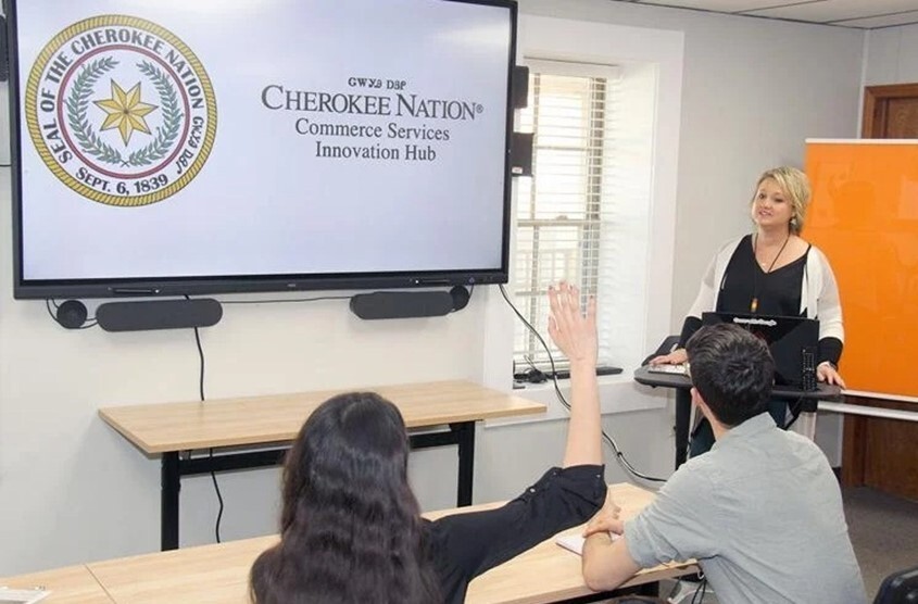 People listening during a presentation given by the Cherokee Nation in a conference room