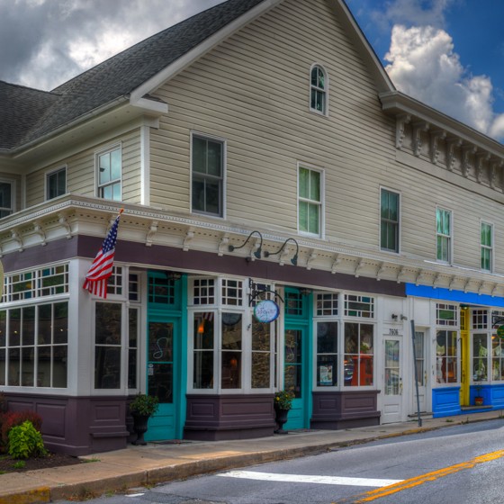 Brightly colored historic buildings line a narrow street.
