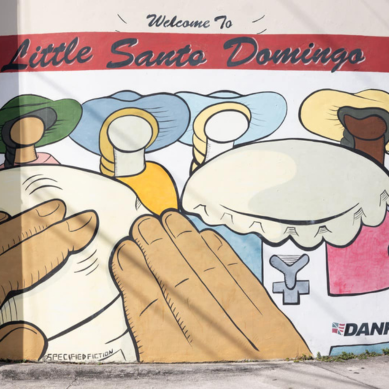 A mural in Little Santo Domingo in Miami, Florida, mural shows hands playing the drums.